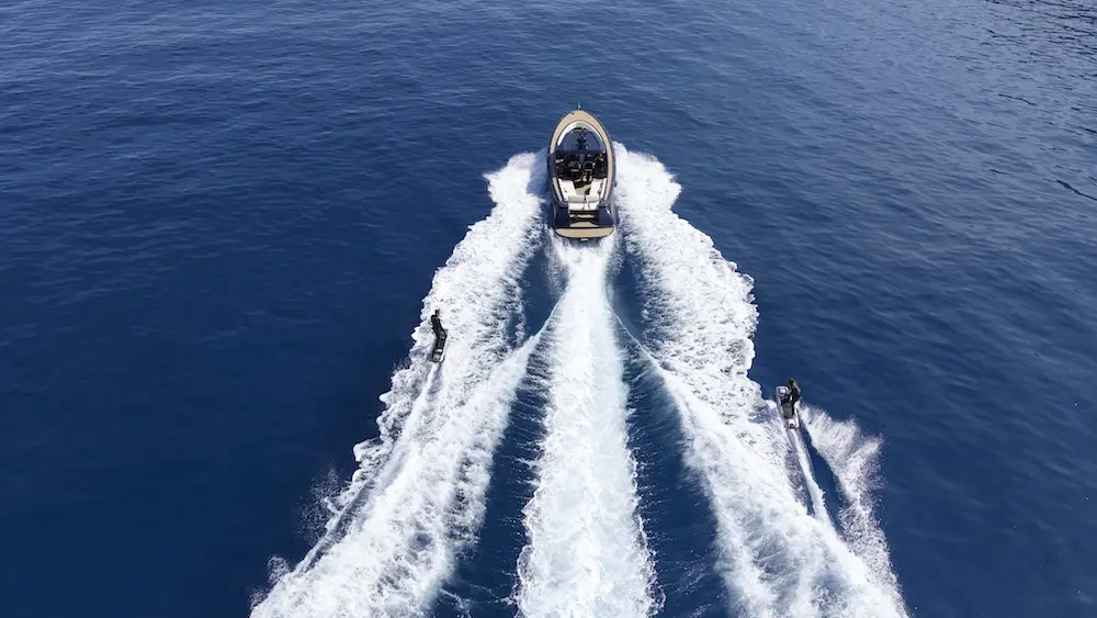 Two people behind a boat riding Awake boards.